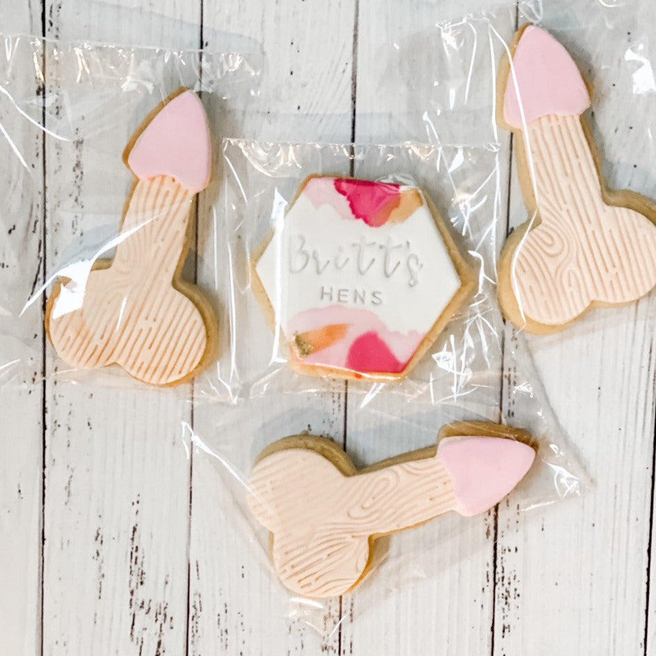 penis shape cookies for hens party on white background with watercolour cookie in middle in hexagon shape